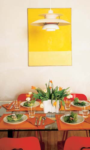 Susan and Rob bought their dining room table, chairs and lamp secondhand. They purchased the dining room artwork - 'Yellow Circle, Yellow Square' by Oli Sihvoven - at an online art auction.